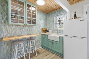 a kitchen with green cabinets and a white refrigerator at Terrapin Station I in Chicken Island