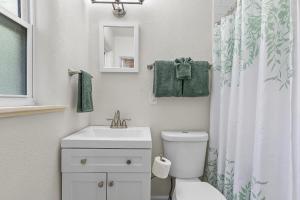 a bathroom with a toilet and a sink and a shower curtain at Terrapin Station I in Chicken Island +37 photos