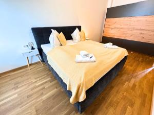 a hotel room with a bed with towels on it at Lake View Suite in Mörbisch am See
