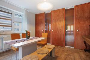a living room with a table and chairs and a piano at Allgäu Space in Marktoberdorf