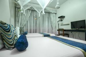 a hotel room with two beds and a television at Ridar Hotel in Seeta