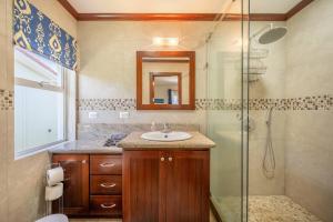 a bathroom with a sink and a shower at Beautiful Beachfront 2br Condo, With Full Kitchen in Tamarindo +18 photos