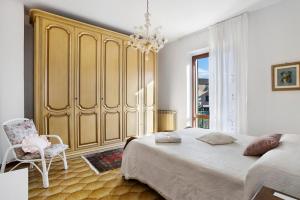 a bedroom with a large bed and a chair at Casa Vanda in Arcola