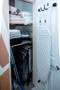 a walk in closet with a door open with clothes at Avalon Sunrise our enchanting Glastonbury cottage in Glastonbury +45 photos