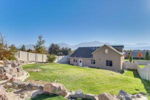 a house on a hill with a fence at Hike, Golf and Ski Family Home in South Jordan in South Jordan