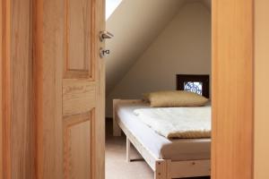 Un dormitorio con una cama y una puerta abierta. en Fewo Hohe Liebe, en Rathmannsdorf