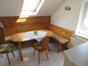 a kitchen with a wooden table and two chairs at Ferienwohnung Zahn in Oelsnitz +25 photos
