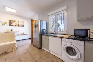 a kitchen with a washer and dryer in a room at Nazareno in Níjar