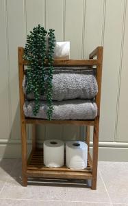 a towel rack with towels and a plant on it at Newditch Farm - BRS Airport in Bristol