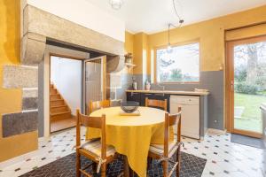 a kitchen and dining room with a table and chairs at Studio avec terrasse au calme in Concarneau