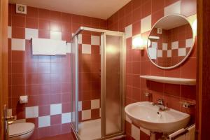 a bathroom with a toilet and a sink and a mirror at Apartment 5 - Zur Sonne in Laion +17 photos