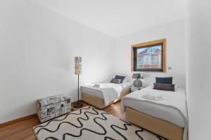 a bedroom with two beds and a couch at GuestReady - Moledo's beach and sun in Santana +43 photos