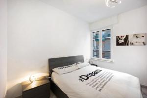a bedroom with a bed and a window at Sanremo casa vista mare in Sanremo