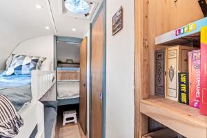 a small bedroom with a bunk bed and a staircase at Desert Dream Airstream in Tombstone
