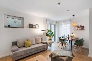 a living room with a couch and a table at Wohnung Familienglück Nähe München in Pfaffing