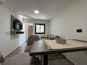 una sala de estar con una mesa y un sofá en 250 Deptos Temporarios, en San Fernando del Valle de Catamarca