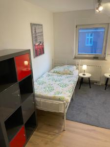 a small bedroom with a bed and a window at Gemütliche Dachgeschoss Wohnung in Selm