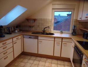 a kitchen with a sink and a window at Gemütliche Dachgeschoss Wohnung in Selm