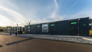 a row of green shipping containers on the side of a road at Roatel Schipkau (A13) my-roatel-com in Schipkau