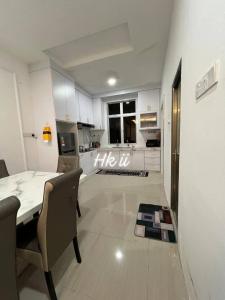 a kitchen with a table and chairs in a room at Homestay Kayangan Gua Musang 2 in Gua Musang