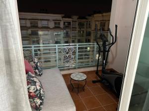 a room with a balcony with a treadmill and chairs at Appartement Haut standing in Mohammedia
