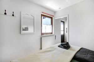 a bedroom with a bed and a window at Gartenwohnung in Westerdeichstrich +22 photos