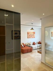 a living room with a couch and a bed at Pearl Rabat Stay 75 TV POOL in Rabat