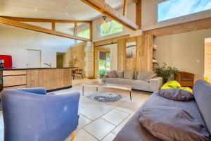 a living room with a couch and a table at La longère d'Astérius in Saint-Astier