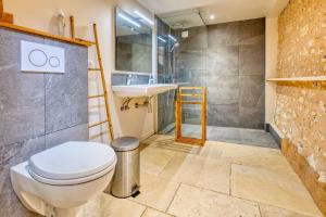 a bathroom with a toilet and a sink at La longère d'Astérius in Saint-Astier