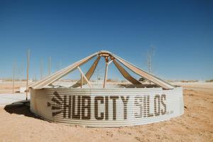 a large sign in the middle of the desert at Hub City Silos in Doud