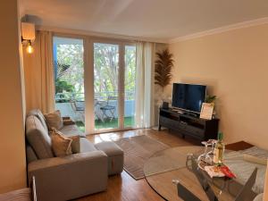 a living room with a couch and a tv at Golf del Sur GreenPark apartments with pool Corbeta 118 in San Miguel de Abona