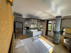 a large bathroom with a large bed and a tub at TEA Prizren Hotel in Prizren