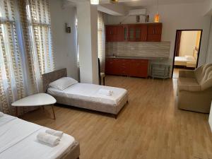 a living room with two beds and a couch and a room at TEA Prizren Hotel in Prizren