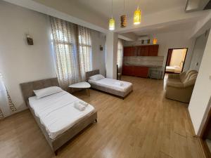 a large room with two beds and a couch at TEA Prizren Hotel in Prizren
