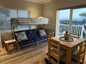 a living room with a couch and a bunk bed at Yellow Wood 1 in Hermanus
