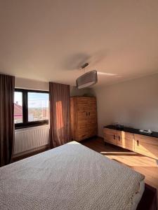 Un dormitorio con una cama grande y una ventana en Charming Little House in Brad, en Brad