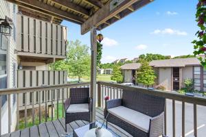 a patio with two chairs on a deck at Branson Sunny Daze - Sleeps 4 in Branson