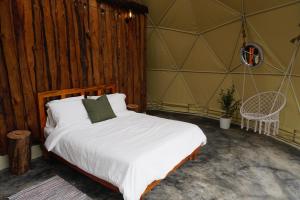 a bedroom with a bed in a tent at Eco Domes Couples Getaway - Waterfall and Mountain Views in Jarabacoa