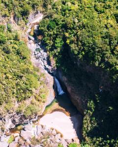 an aerial view of a river in a forest at Eco Domes Couples Getaway - Waterfall and Mountain Views in Jarabacoa