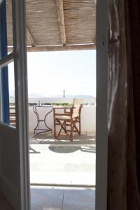 an open door to a patio with a table and chairs at Sorokos Koufonissia in Koufonisia