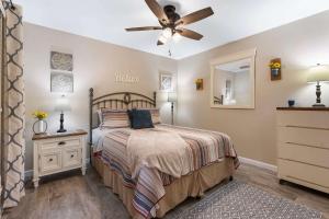 a bedroom with a bed and a ceiling fan at Greenside Retreat - Pointe Royale in Branson