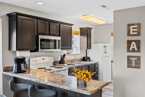 a kitchen with black cabinets and a counter top at Silver Lake Hideaway - Chic 2 BDR Dog Friendly in Branson