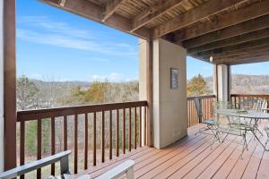 a large deck with a table and chairs on it at Silver Lake Hideaway - Chic 2 BDR Dog Friendly in Branson