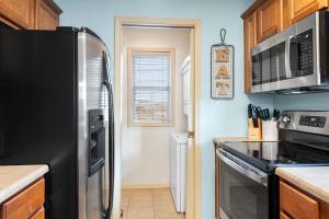 a kitchen with a stainless steel refrigerator and a window at Par 7 Penthouse at StoneBridge Resort in Branson West