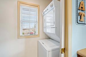 a kitchen with a white refrigerator and a window at Par 7 Penthouse at StoneBridge Resort in Branson West