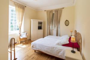 a bedroom with a bed and a table with a lamp at Domaine de Bellegarde in Soustons +31 photos