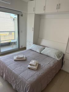 a bedroom with a bed with two towels on it at Monoambiente con amenities Y MAS in Buenos Aires +27 photos