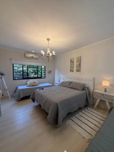 a bedroom with two beds and a window at Sumergite en una gran piscina o jacuzzi in Gualeguaychú +86 photos