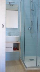 a bathroom with a sink and a glass shower at Antica Capua Bed and Breakfast in Santa Maria Capua Vetere