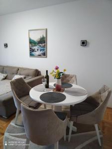 a living room with a white table and chairs at Apartment "Splendid J&R" in Bijeljina